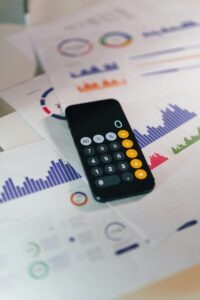 Calculator on graphs showing financial data and analytics. Ideal for business and finance themes.